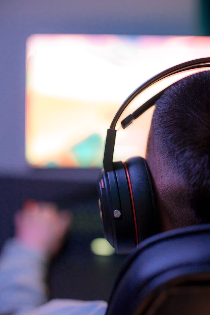 Person Wearing Headphones While Using a Computer